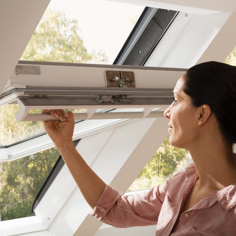 VELUX window with woman opening it