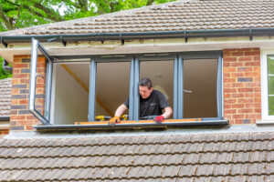 man fixing windows