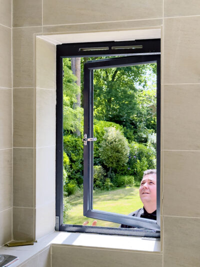 man looking at a window